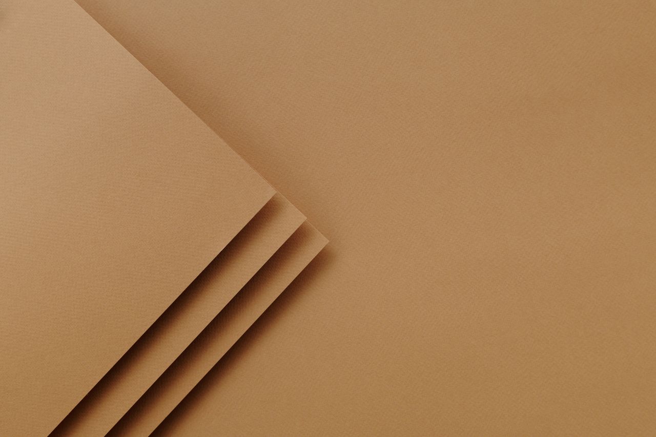Abstract brown textured paper layers creating a minimalist background design.